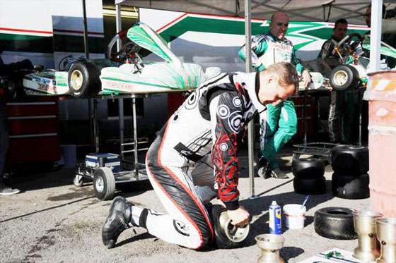 Michael Schumacher removing a tyre from a kart wheel